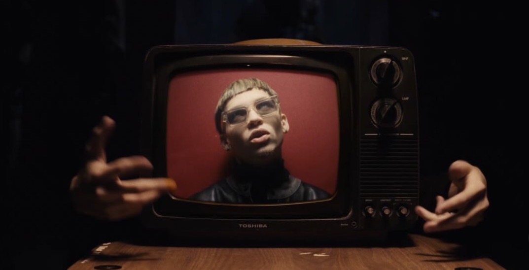 Performer framed inside a vintage television